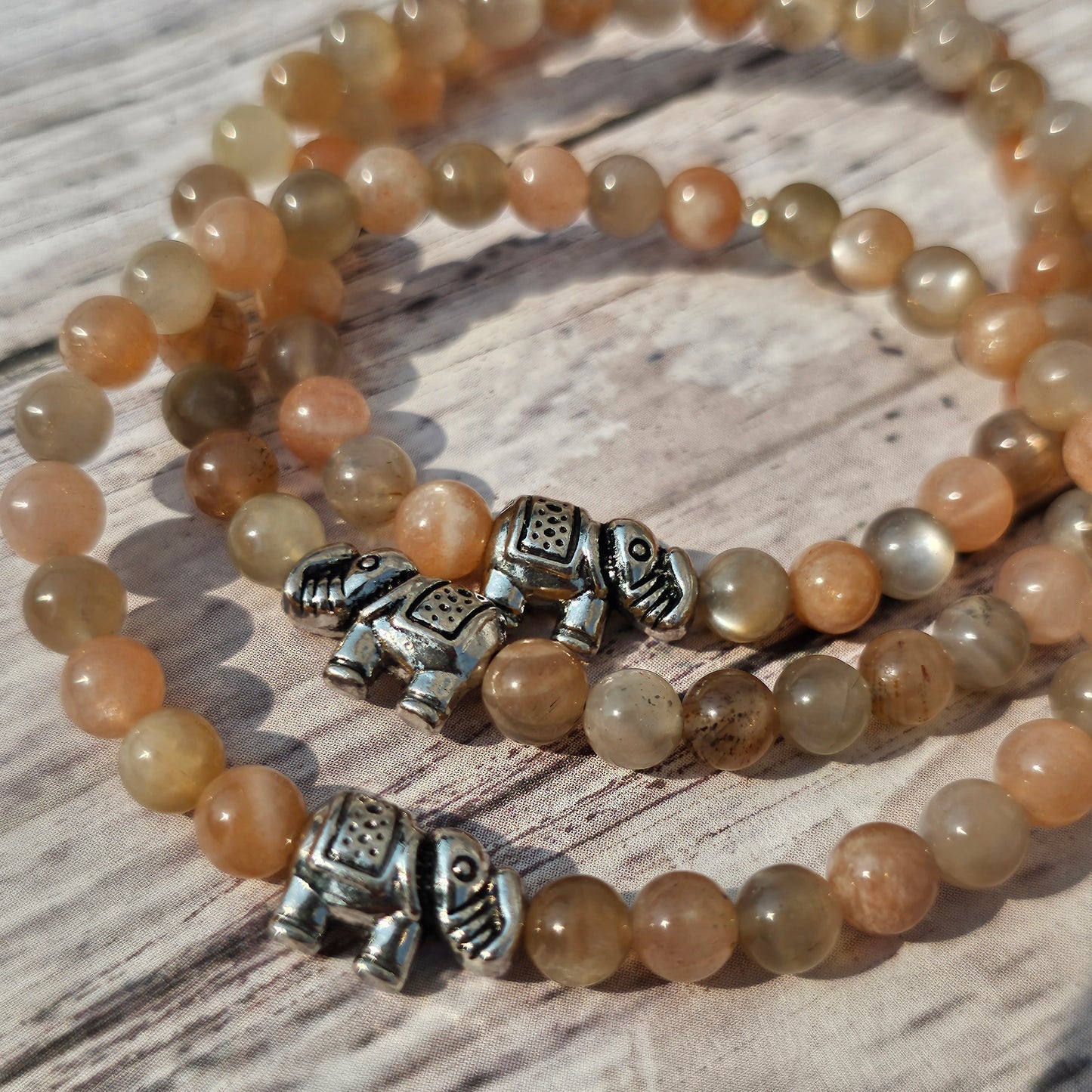 5mm Reiki Infused Skeletal Sunstone Bracelet with Elephant Charm